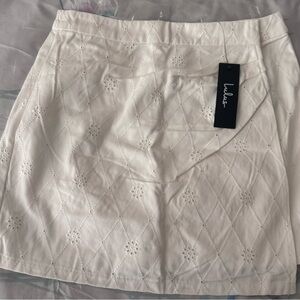 Truly Lovable Ivory Eyelet Embroidered Wrap Mini Skirt
Color: Ivory size S
